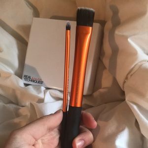 2 makeup brushes and makeup holder